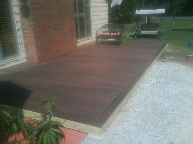 Freshly stained wood deck built against a brick home in Chebeague Island